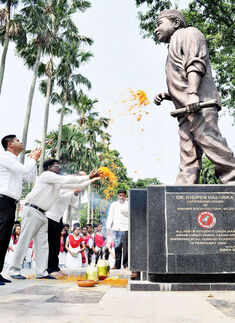People pay floral tribute to the statue of music maestro