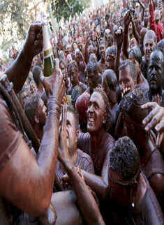 Revellers covered in paint take part