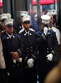 Firefighters attend a ceremony at the Fire Department of New York headquarters