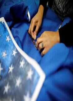 An employee works on the costume of Minnie Mouse