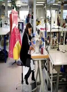 An employee works on a sewing