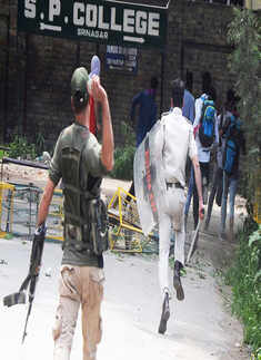 Policemen chasing SP College protestors