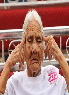 An old woman participates in a yoga class