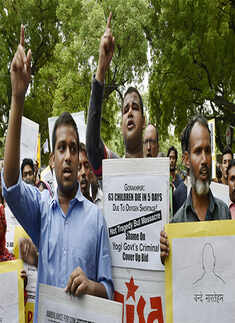 Social activists shout slogans during a protest rally