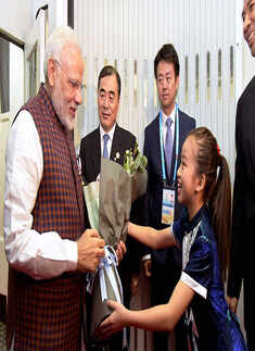 Narendra Modi is greeted by a Chinese girl