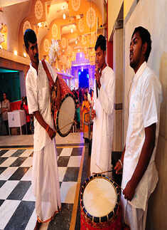 Devotees perform during the Shashti Puja