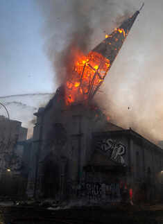Two churches set ablaze as protests turn violent in Chile