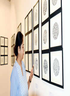 Art lovers attend an exhibition on bottle art and freehand mandalas