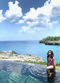 Mommy-to-be Freida Pinto flaunts her baby bump in her latest swimsuit pictures