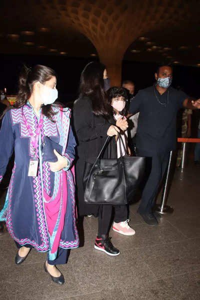 Aishwarya Rai holds Aaradhya's hand as she makes her way out of the airport  with husband Abhishek Bachchan – See pics