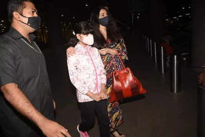 Aishwarya Rai holds Aaradhya's hand as she makes her way out of the airport  with husband Abhishek Bachchan – See pics